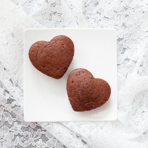 Two heart-shaped chocolate cakes on a white plate